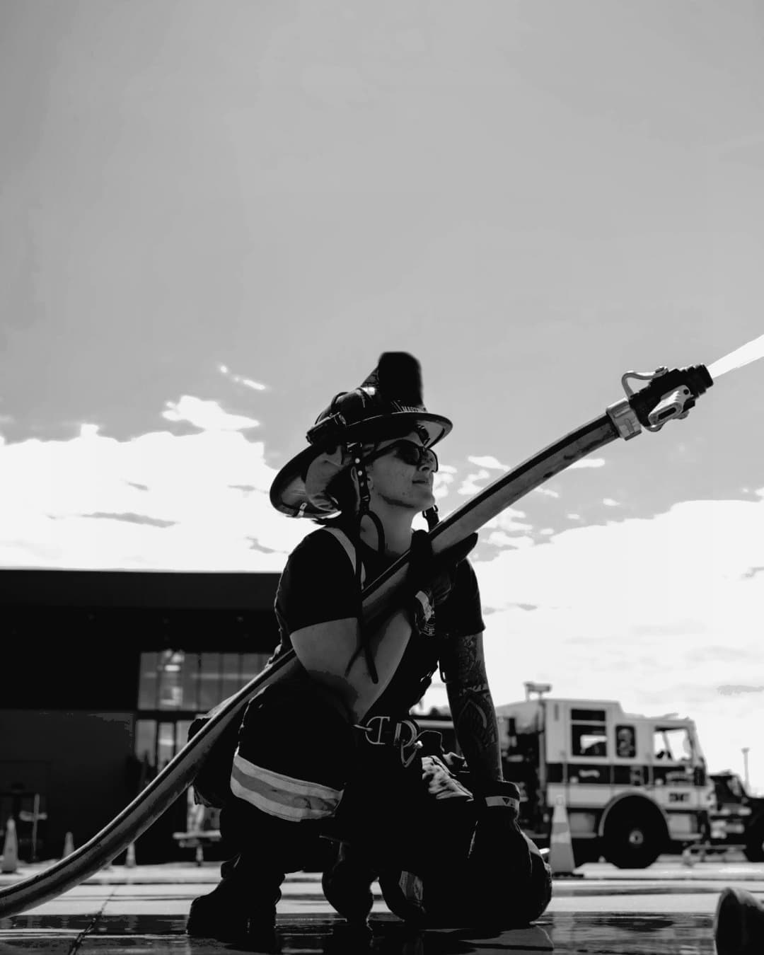 Firefighter in turnout gear with hose